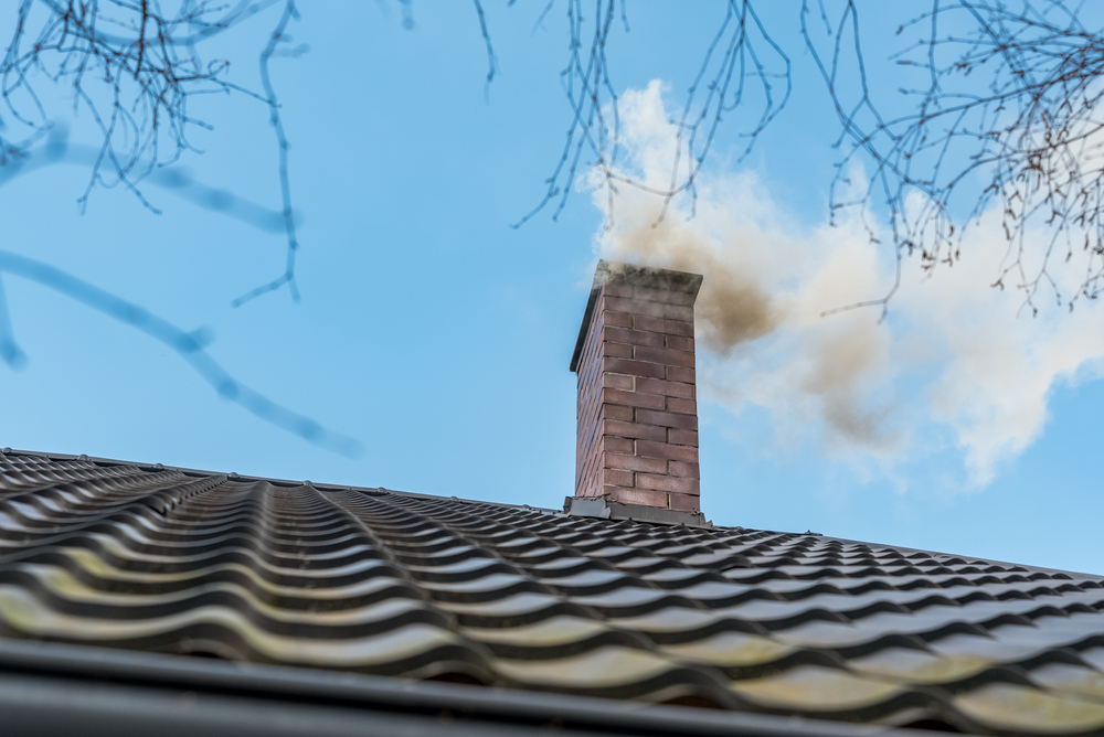 Chimney on the roof of a detached house.